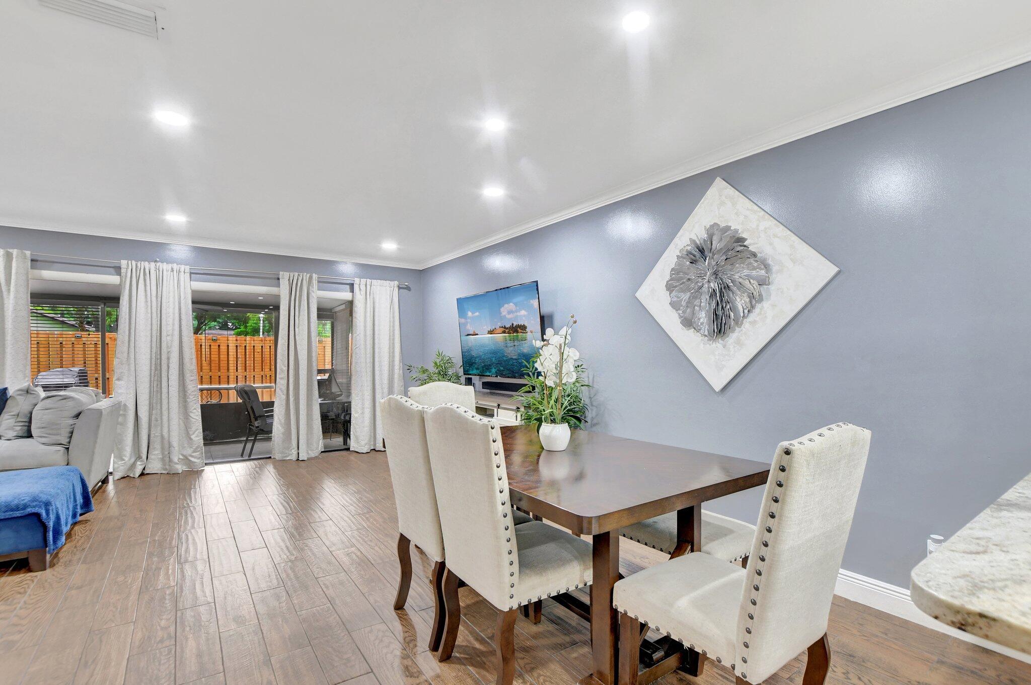 23398 Southwest 54th Way, Unit A Boca Raton, FL 33433 - Photo 5 of 29 a view of a dining room with furniture and wooden floor