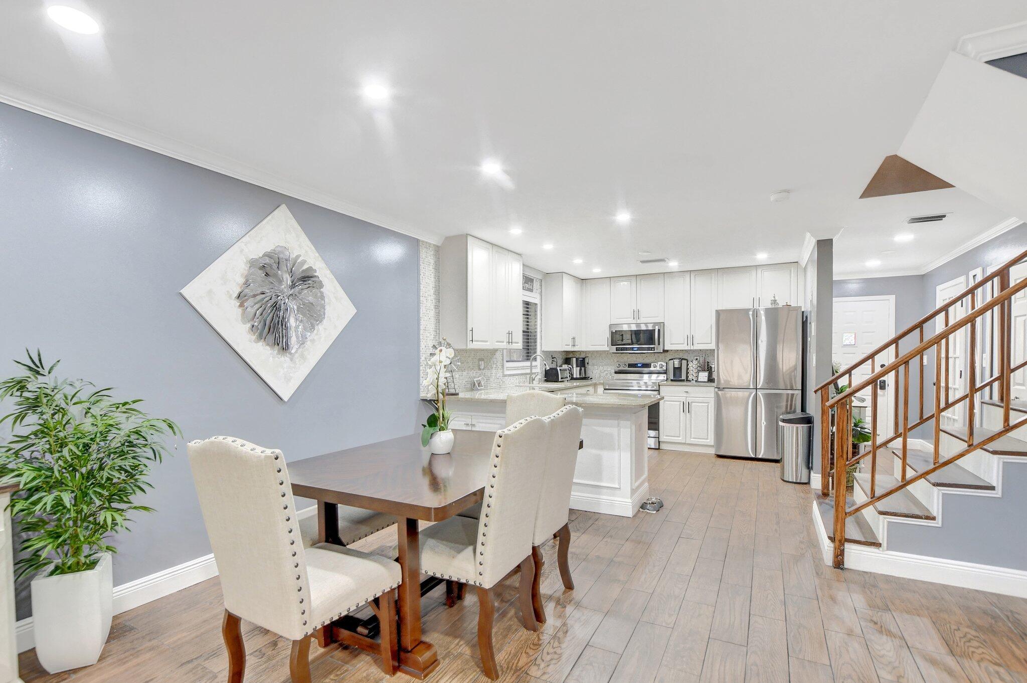 23398 Southwest 54th Way, Unit A Boca Raton, FL 33433 - Photo 6 of 29 a view of a dining room with furniture and wooden floor