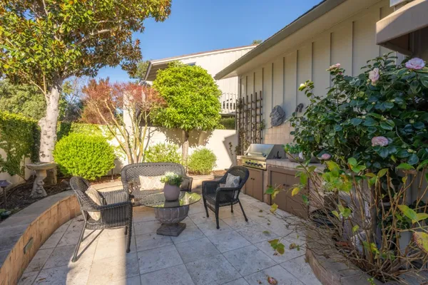 a view of a chairs and table in a backyard