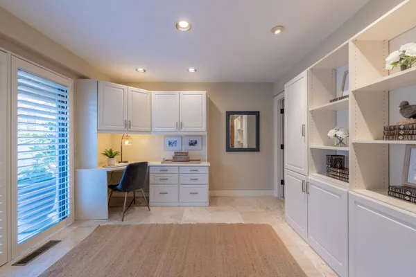 a kitchen with cabinets and wooden floor