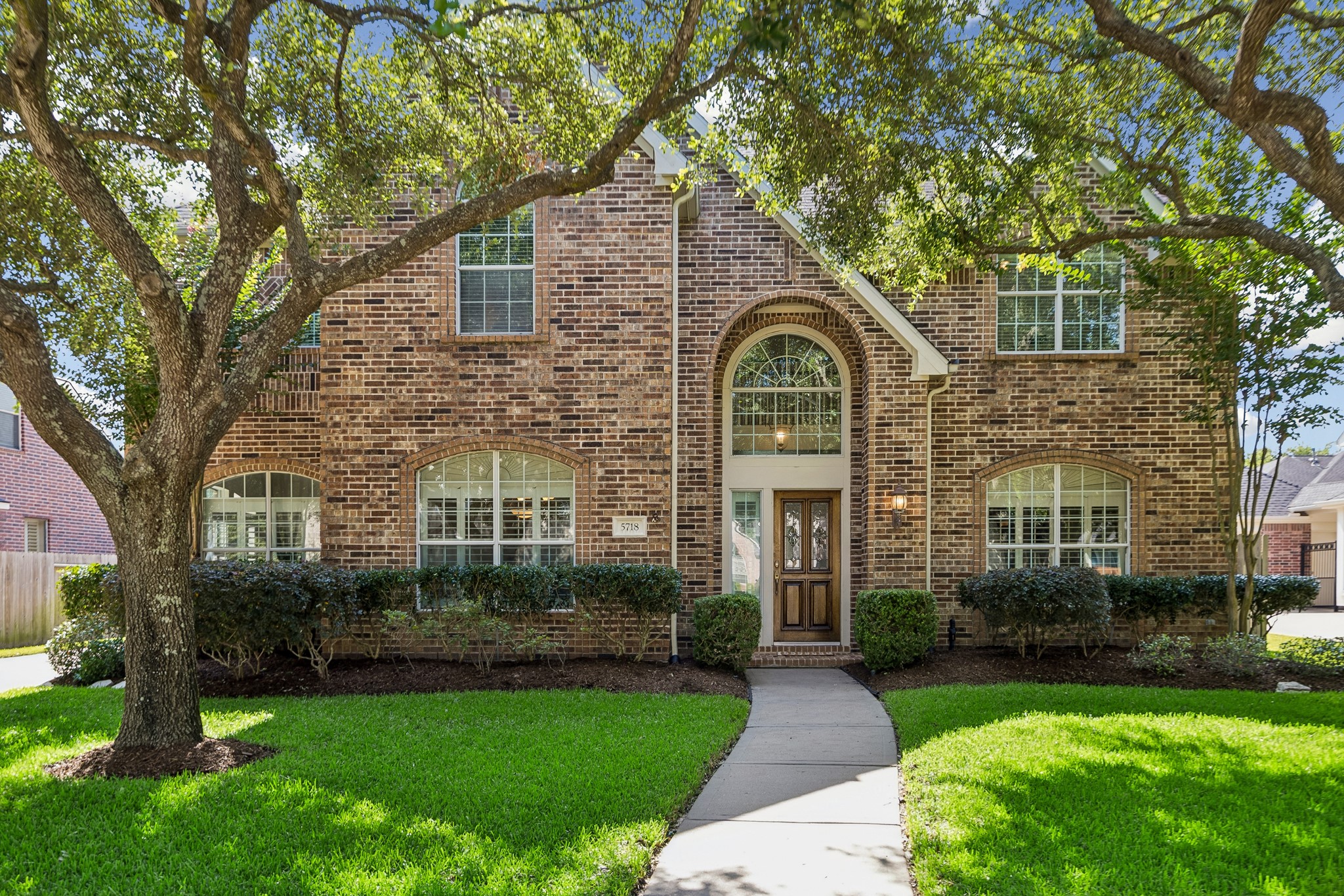 5718 Brennan Ridge Lane Katy, TX 77450 - Photo 34 of 42 CLASSIC CURB APPEAL: Nestled beneath mature shade trees, this stately all-brick home welcomes with timeless architecture, manicured landscaping, and is perfectly positioned on a quiet cul-de-sac just moments from scenic lakes and walking trails in one of Katy’s most desirable communities.