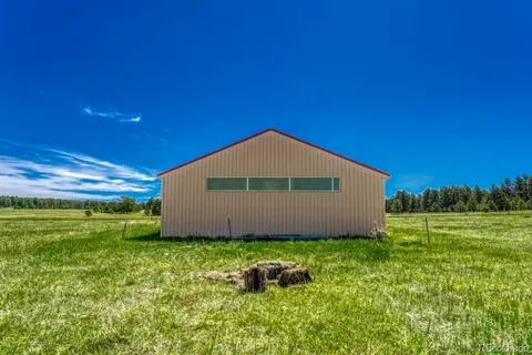 a house with green field in front of it