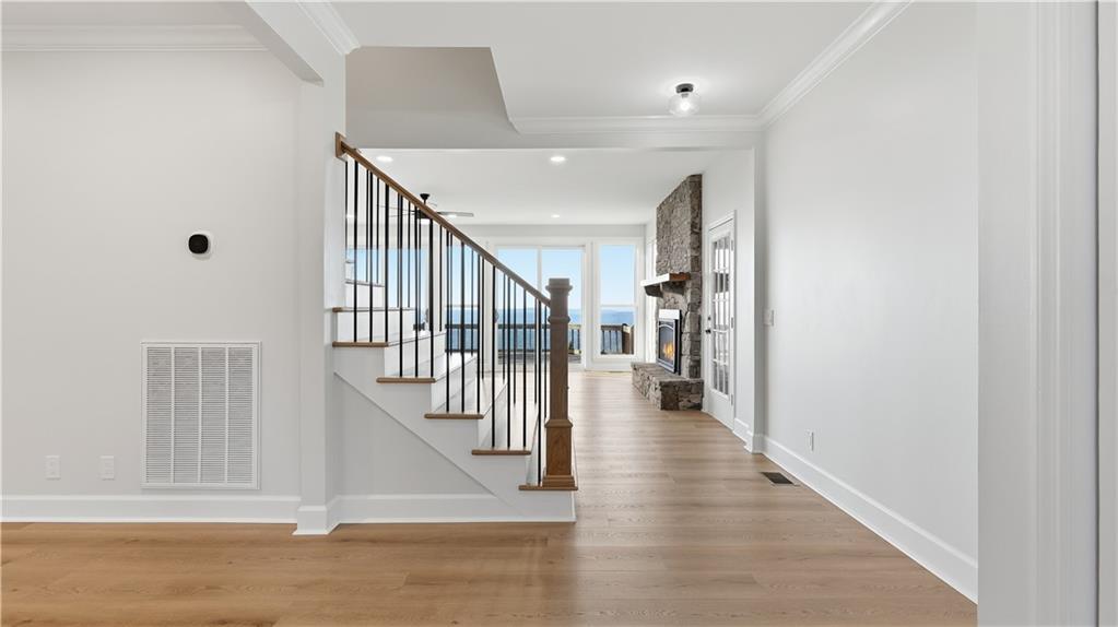 141 Brow Lake Road Lookout Mountain, GA 30750 - Photo 14 of 66 a view of staircase with lots of frames on wall and wooden floor