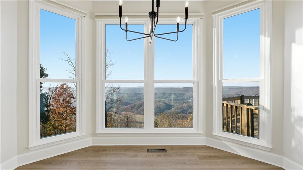 141 Brow Lake Road Lookout Mountain, GA 30750 - Photo 17 of 66 a view of empty room with wooden floor and fan
