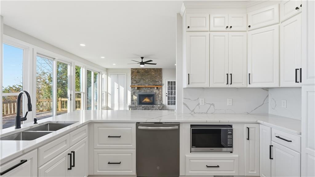 141 Brow Lake Road Lookout Mountain, GA 30750 - Photo 19 of 66 a kitchen with granite countertop white cabinets and white appliances