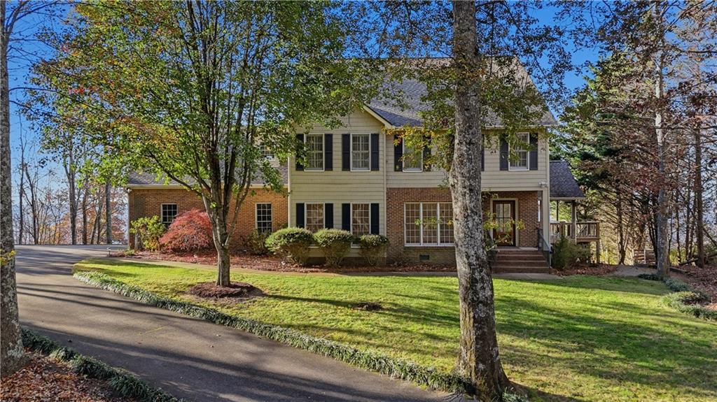 141 Brow Lake Road Lookout Mountain, GA 30750 - Photo 2 of 66 a front view of a house with garden