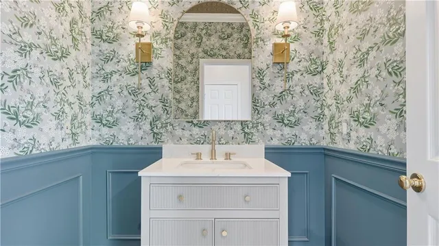 a bathroom with a double vanity sink mirror and bathtub