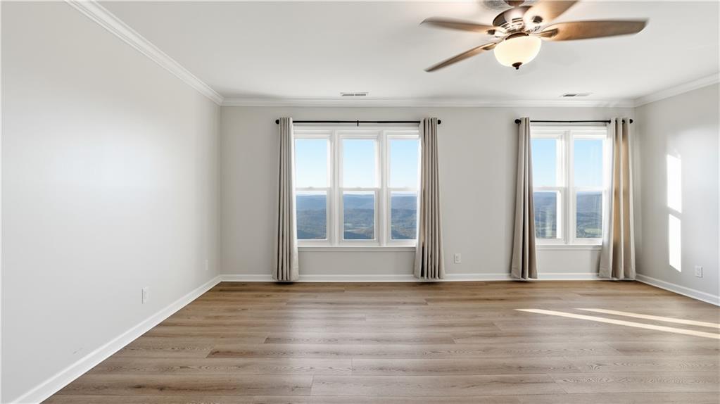 141 Brow Lake Road Lookout Mountain, GA 30750 - Photo 26 of 66 a view of an empty room with wooden floor and a window