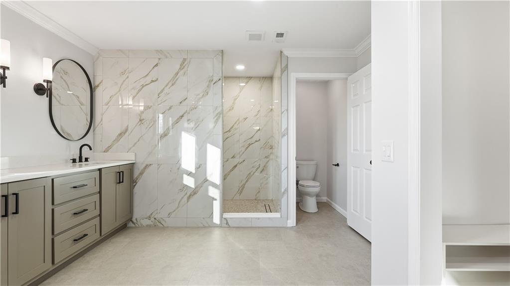 141 Brow Lake Road Lookout Mountain, GA 30750 - Photo 28 of 66 a spacious bathroom with a double vanity sink and a mirror