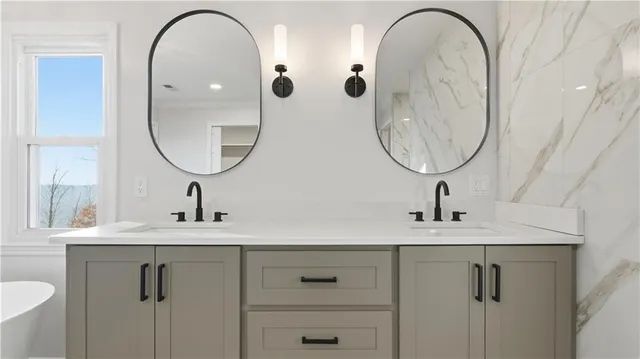 a bathroom with a granite countertop toilet and a sink