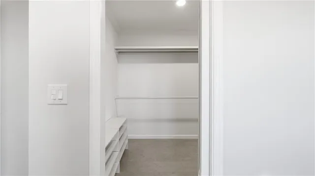 a view of empty room with window and ceiling fan