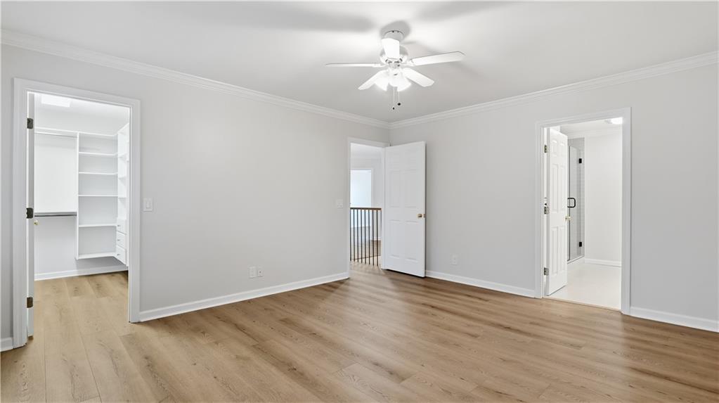 141 Brow Lake Road Lookout Mountain, GA 30750 - Photo 35 of 66 an empty room with wooden floor and ceiling fan