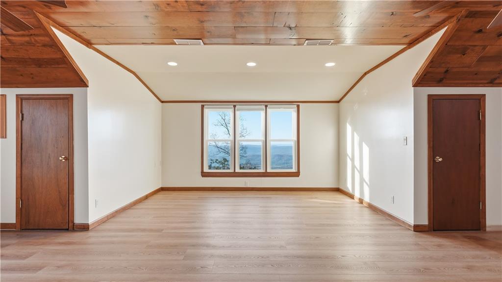 141 Brow Lake Road Lookout Mountain, GA 30750 - Photo 45 of 66 a view of an empty room with wooden floor and windows
