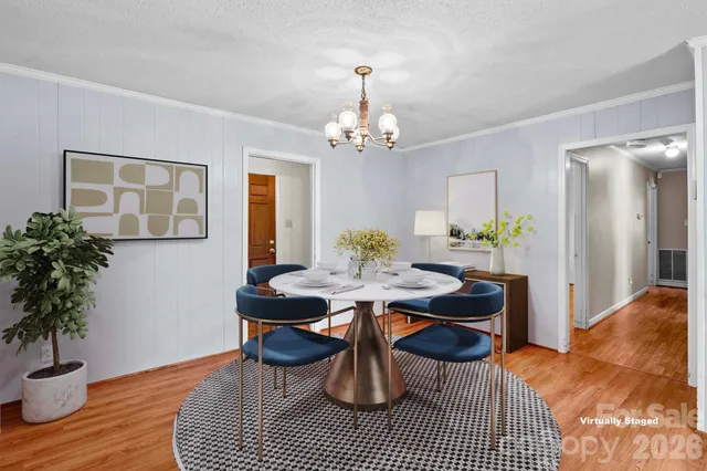a dining room with furniture and wooden floor