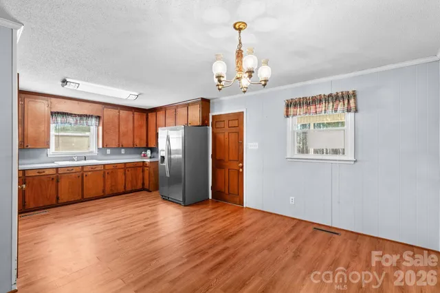 a view of a kitchen with a sink wooden floor and a kitchen