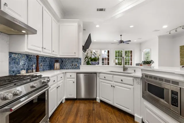 a kitchen with a stove window and cabinets