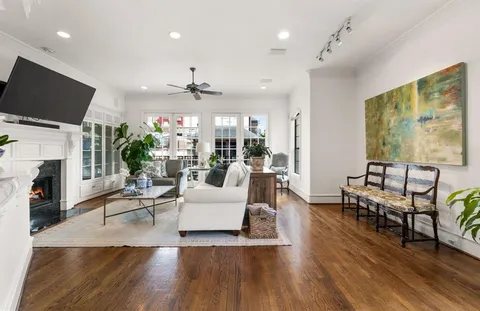 a living room with fireplace furniture and a flat screen tv