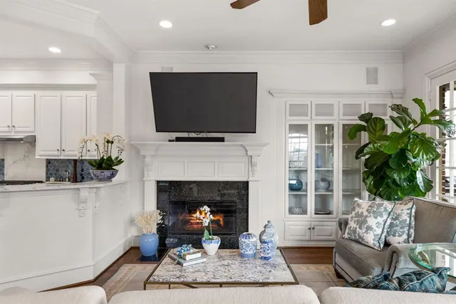 a living room with furniture a flat screen tv and a fireplace