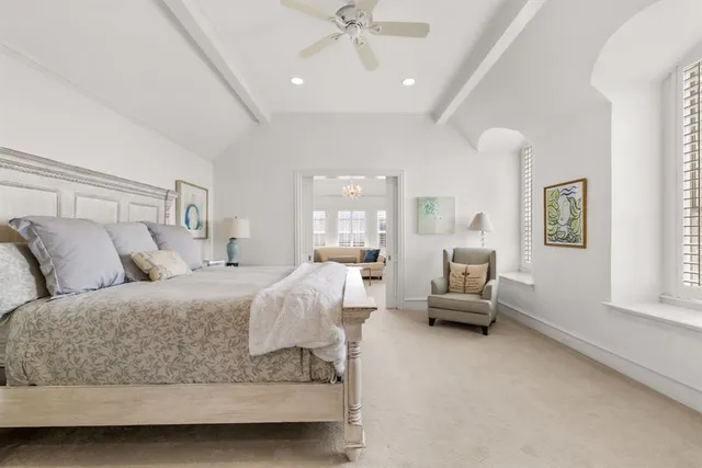 a spacious bedroom with a bed and a window