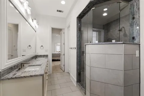 a bathroom with a granite countertop sink and a mirror