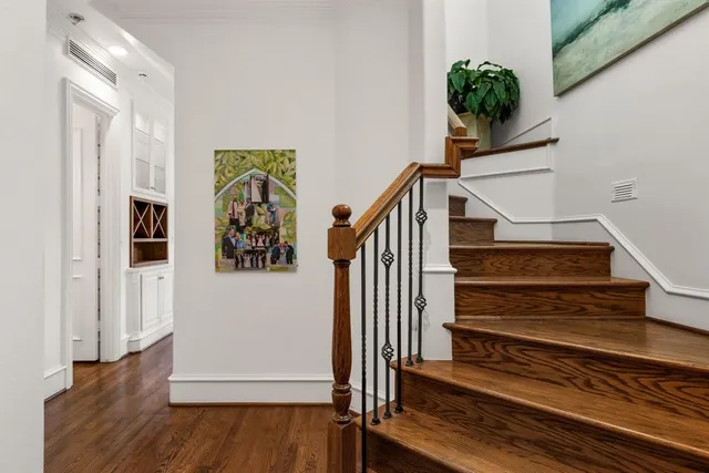 a view of entryway and hall with wooden floor