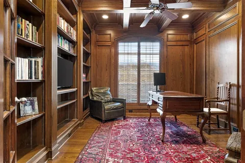 a living room with furniture a rug and a window