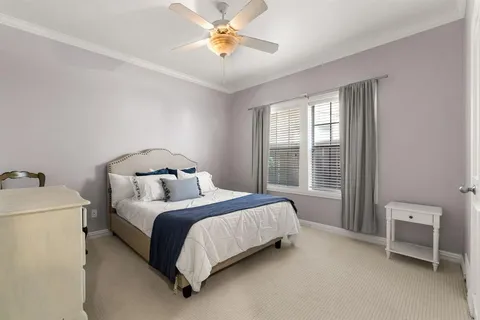 a bed sitting in a bedroom next to a window