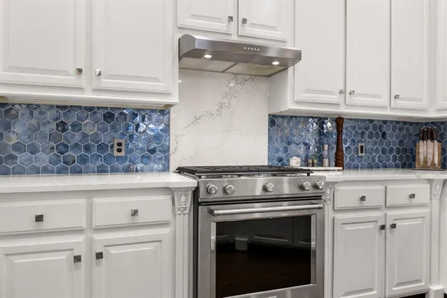 a stove top oven sitting inside of a kitchen