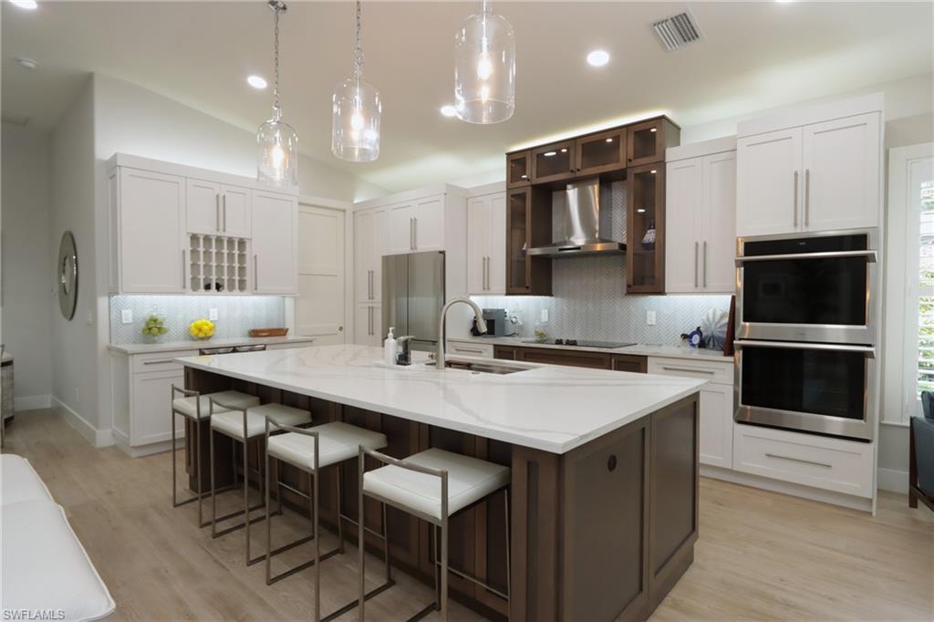 a kitchen with a center island and stainless steel appliances