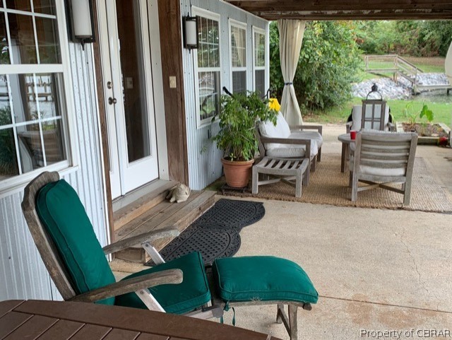 1167 Johns Neck Road Weems, VA 22576 - Photo 10 of 48 an outdoor sitting area with furniture and garden view