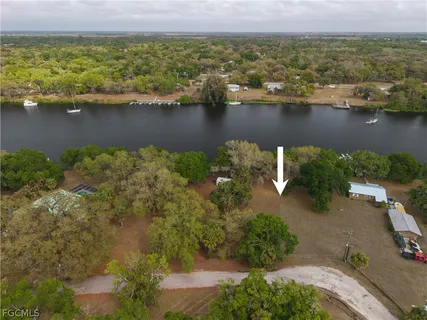 an aerial view of residential building with outdoor space and lake view