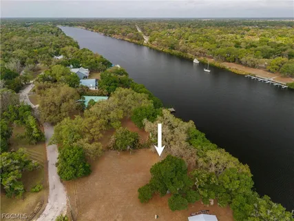an aerial view of a houses with a lake view