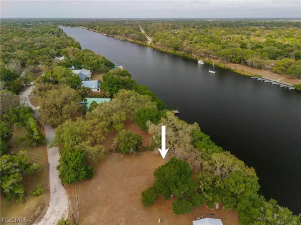 an aerial view of a houses with a lake view