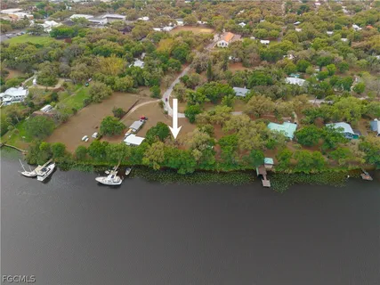 an aerial view of a house with a yard and parking spaces