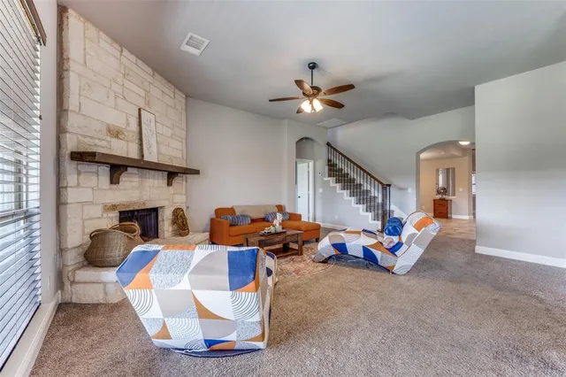 a living room with furniture fireplace and a window