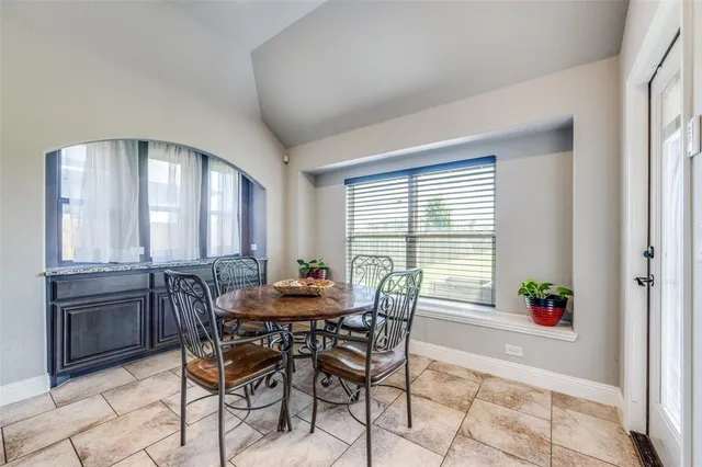 a view of a dining room with furniture and window