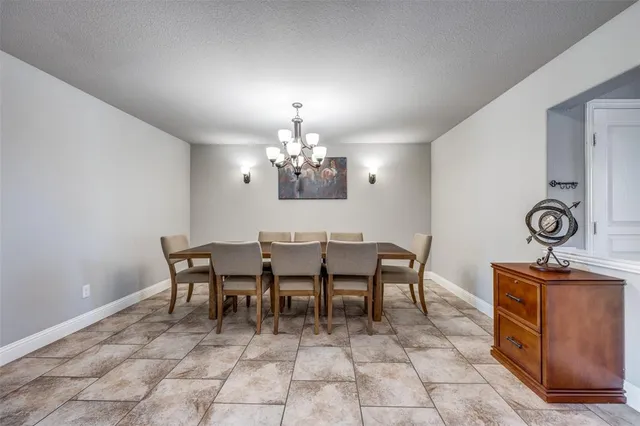 a view of a dining room with furniture and chandelier