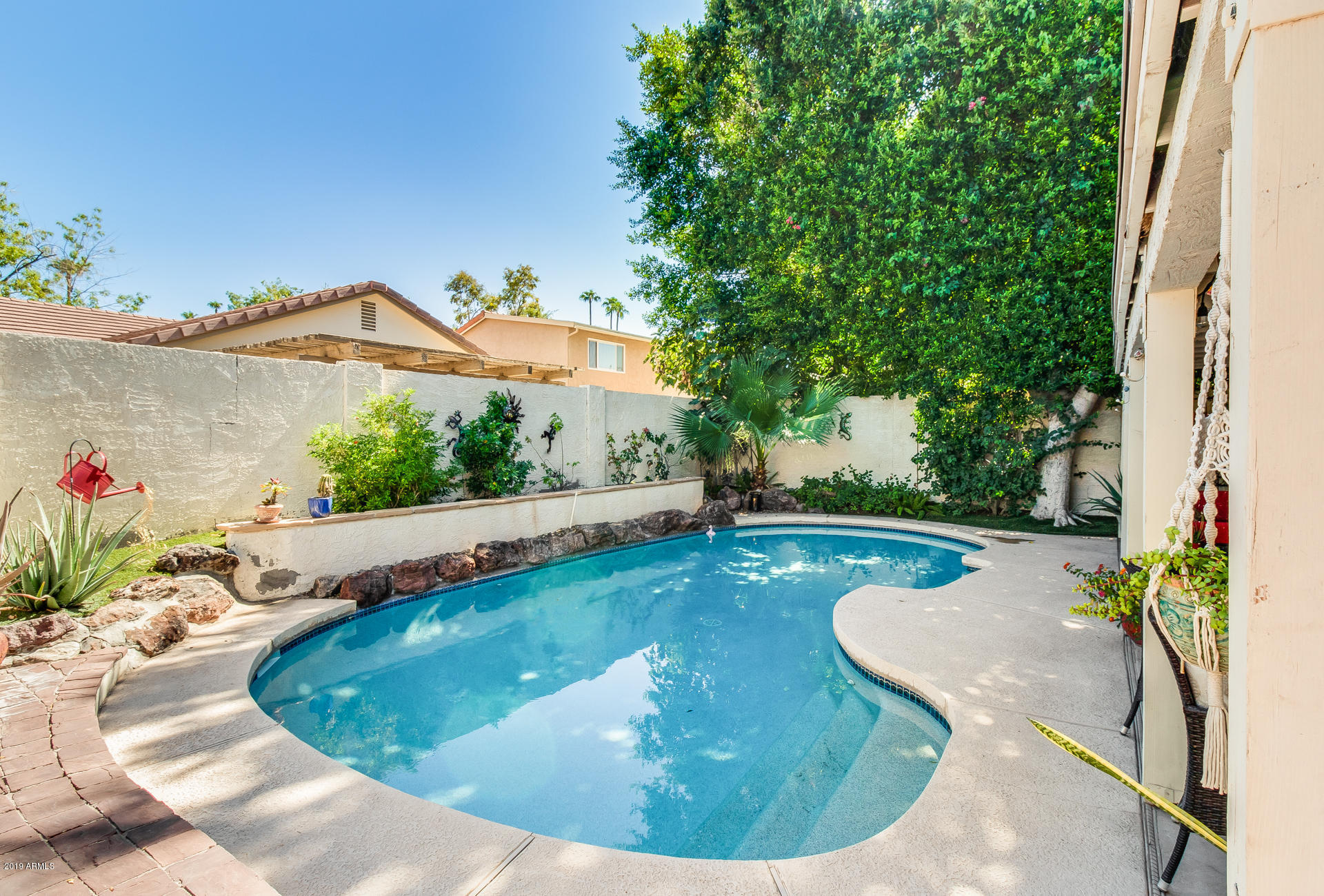 5615 South Crows Nest Road Tempe, AZ 85283 - Photo 28 of 44 a view of a swimming pool with a yard