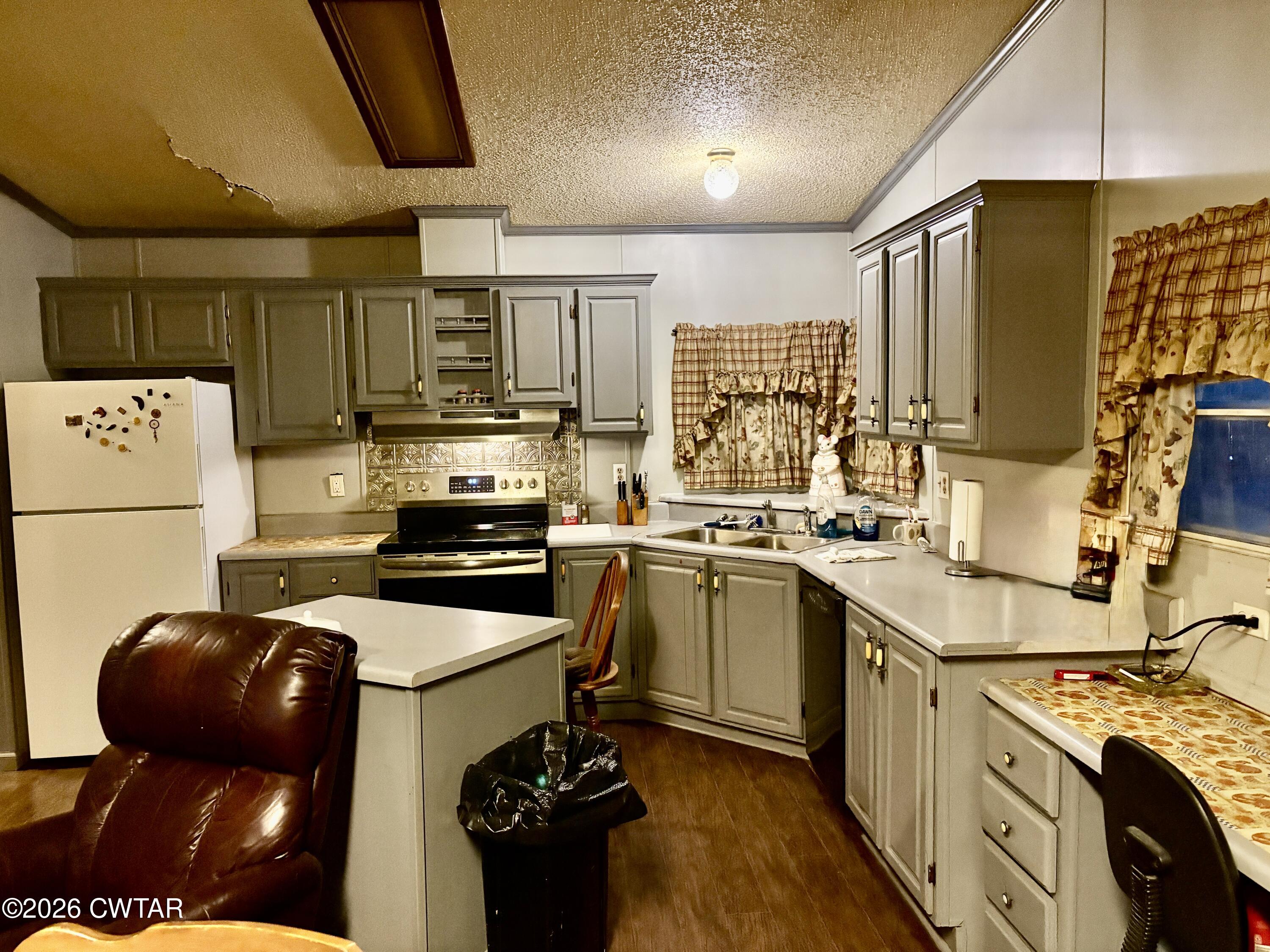 3834 Union Mercer Road Brownsville, TN 38012 - Photo 5 of 15 a kitchen with a sink a stove and refrigerator