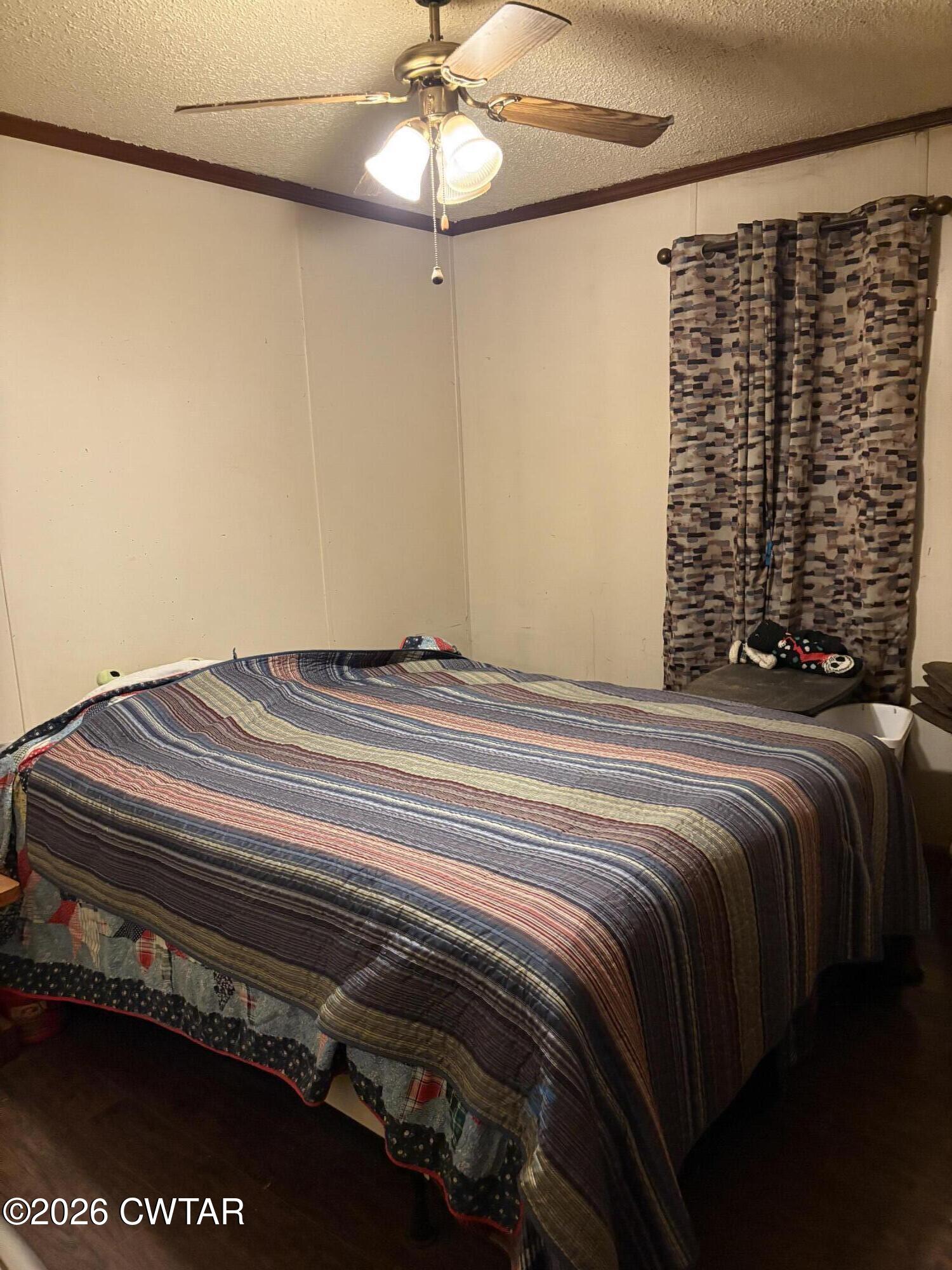 3834 Union Mercer Road Brownsville, TN 38012 - Photo 8 of 15 a bedroom with a bed and a walk in closet