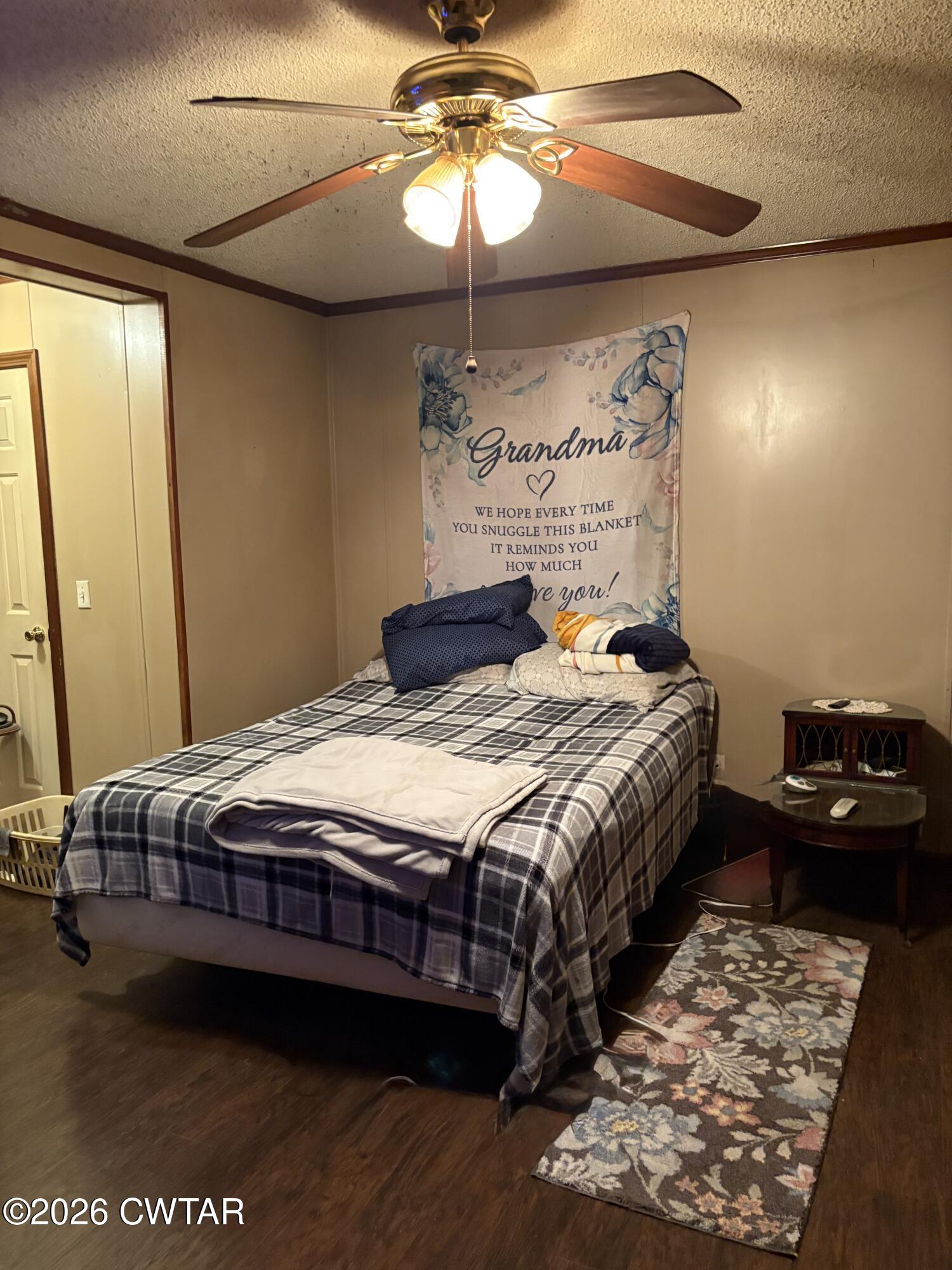 3834 Union Mercer Road Brownsville, TN 38012 - Photo 9 of 15 a bedroom with a bed and a chandelier