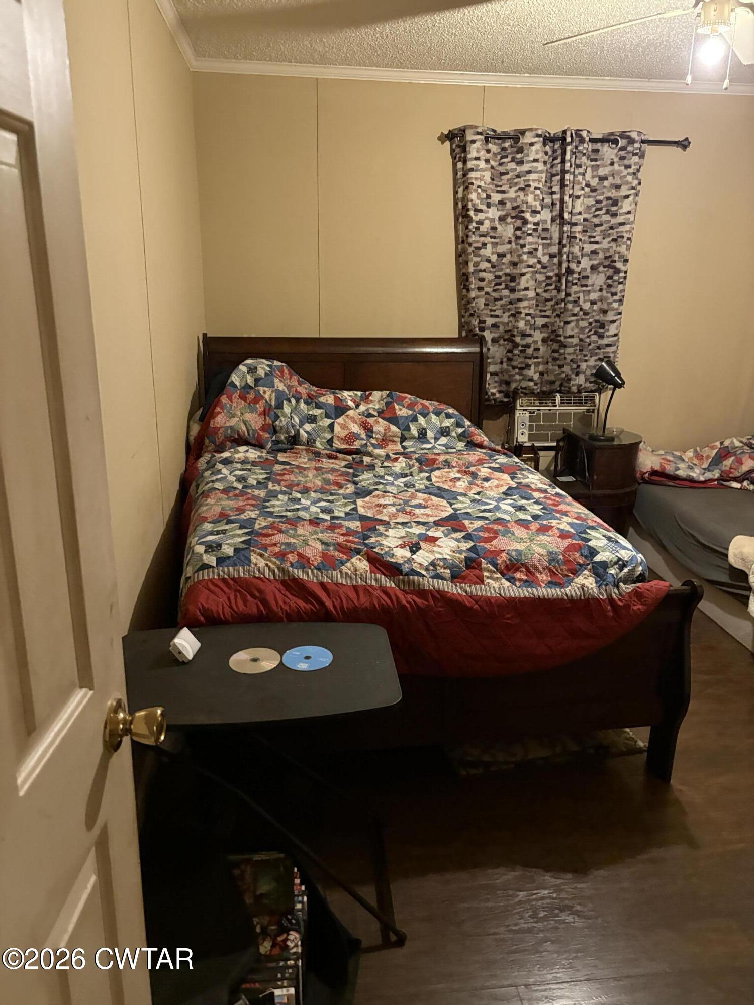 3834 Union Mercer Road Brownsville, TN 38012 - Photo 10 of 15 a bed sitting in a bedroom next to a window