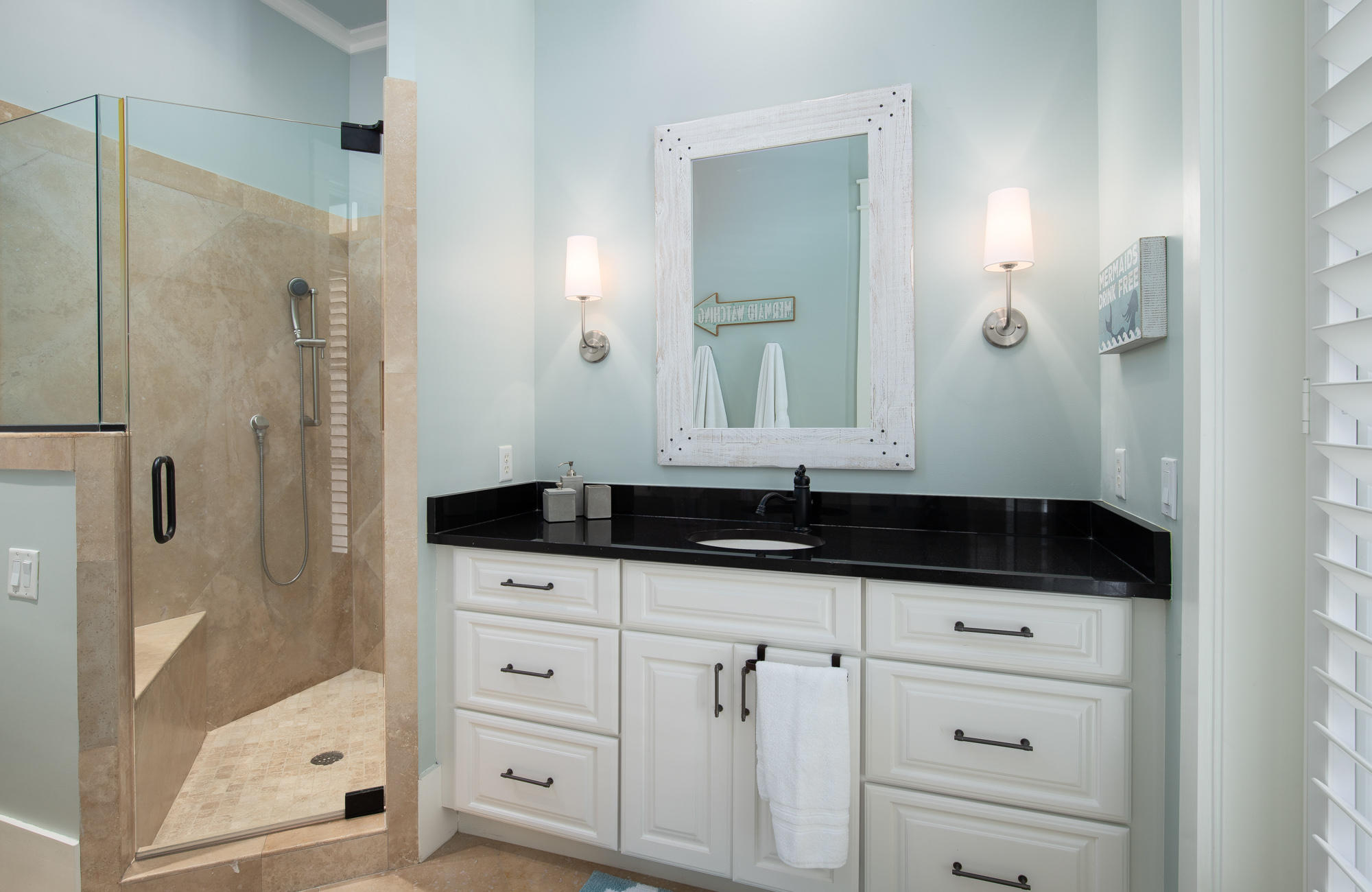 41 Beachcomber Lane Inlet Beach, FL 32461 - Photo 19 of 35 a bathroom with a granite countertop sink a mirror a vanity and a glass door shower