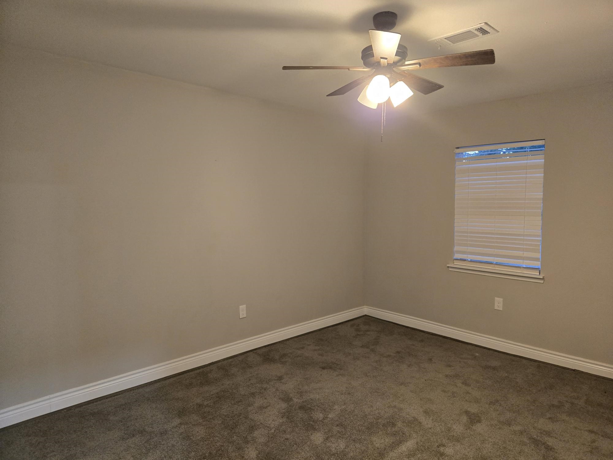 3102 Friar Point Road Houston, TX 77051 - Photo 9 of 11 Carpeted room with ceiling fan, blinds, and abundant natural light.