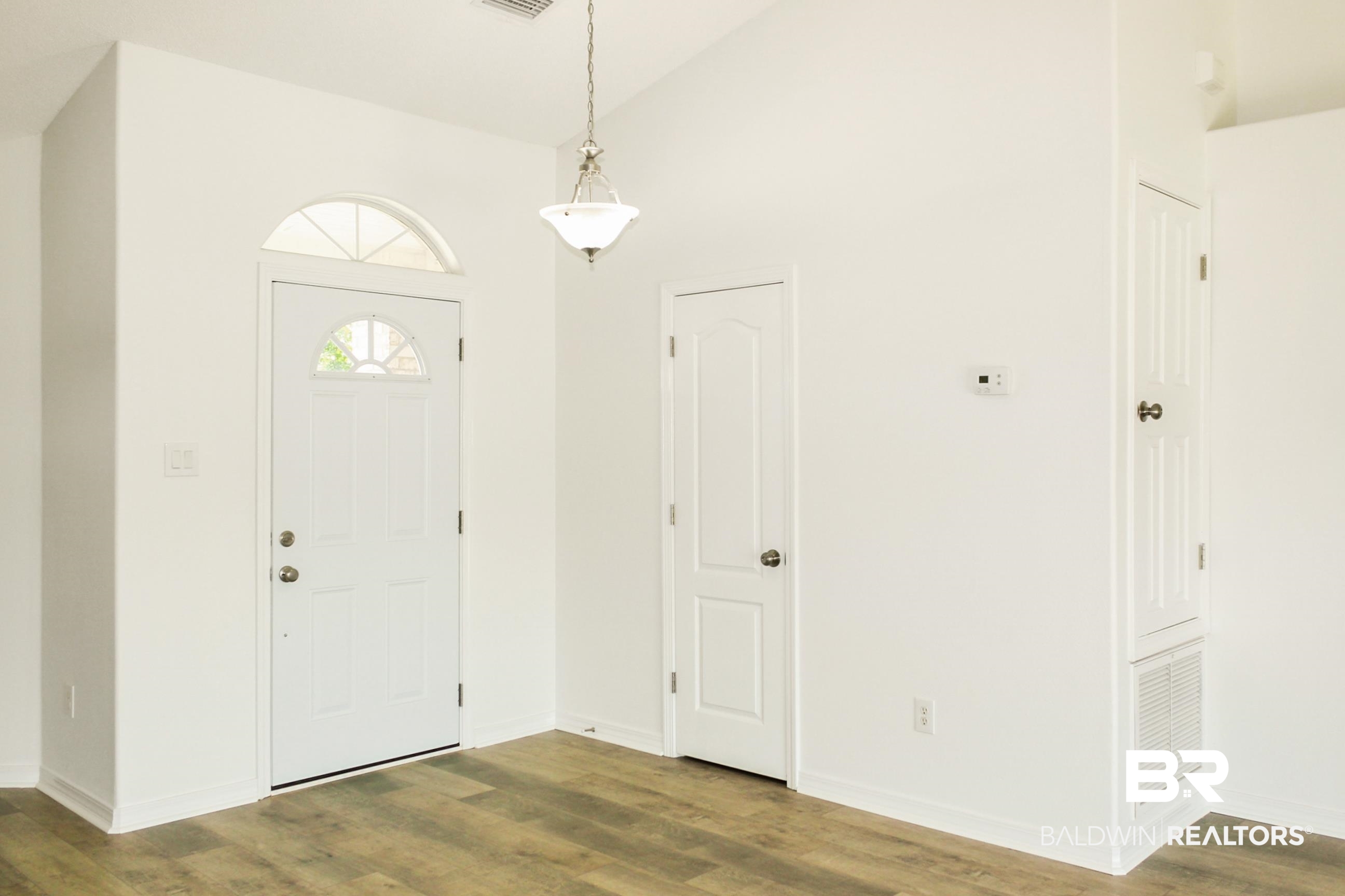 14750 Pawnee Court Foley, AL 36535 - Photo 10 of 34 Entrance foyer featuring wood finished floors and high vaulted ceiling