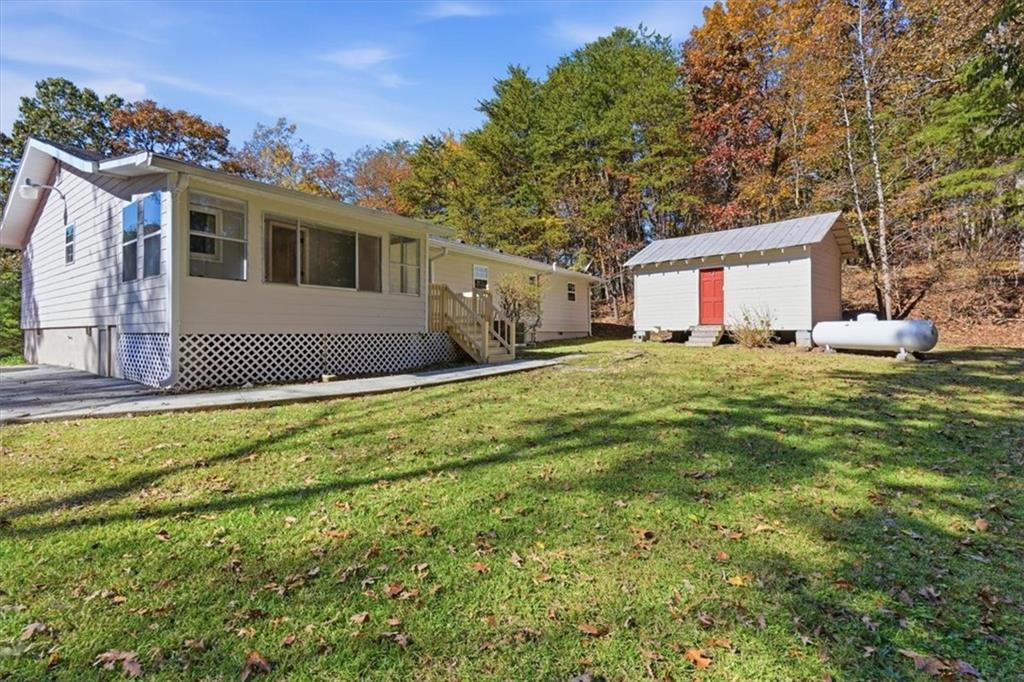 1500 Moores Ferry Road Southwest Plainville, GA 30733 - Photo 15 of 33 a house view with a sitting space and garden