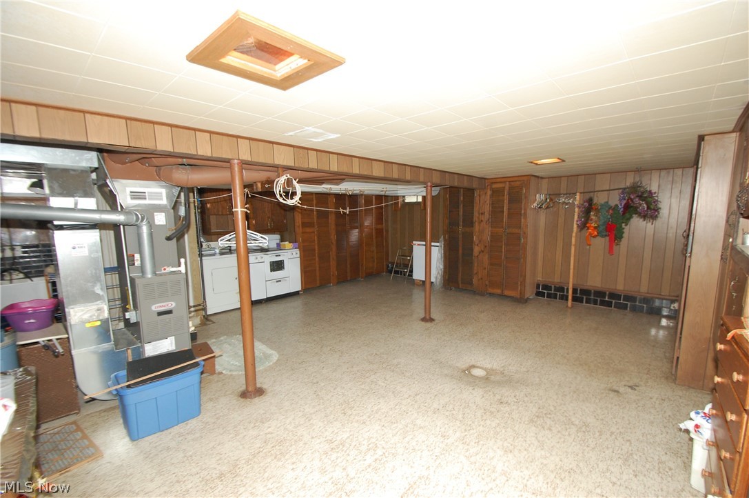 189 Creed Street Struthers, OH 44471 - Photo 14 of 14 Basement featuring wooden walls, washer and dryer, and heating utilities