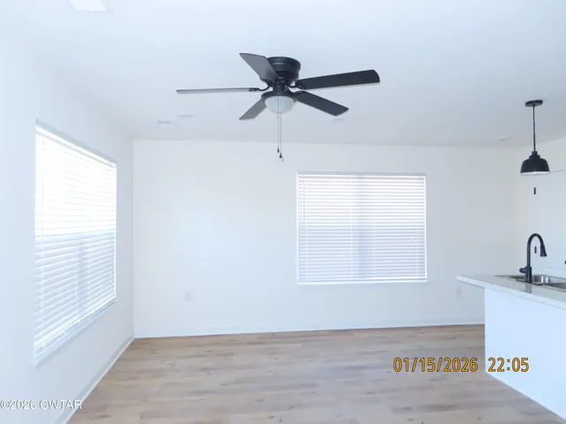 a kitchen with stainless steel appliances a sink a refrigerator and window