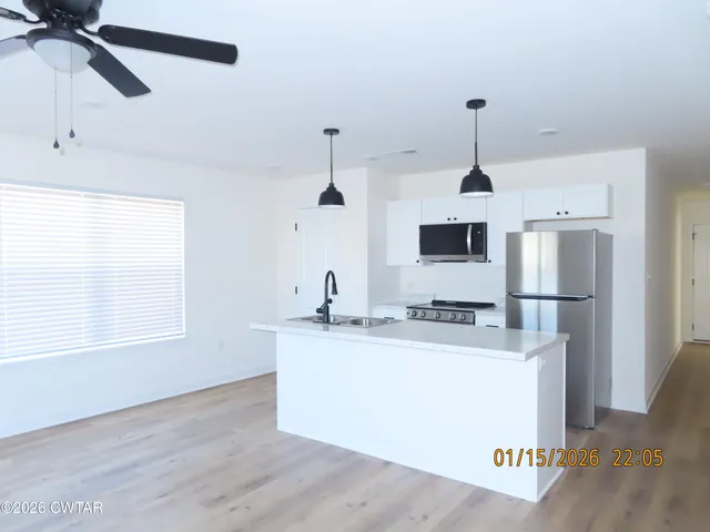 a kitchen with a sink and a window