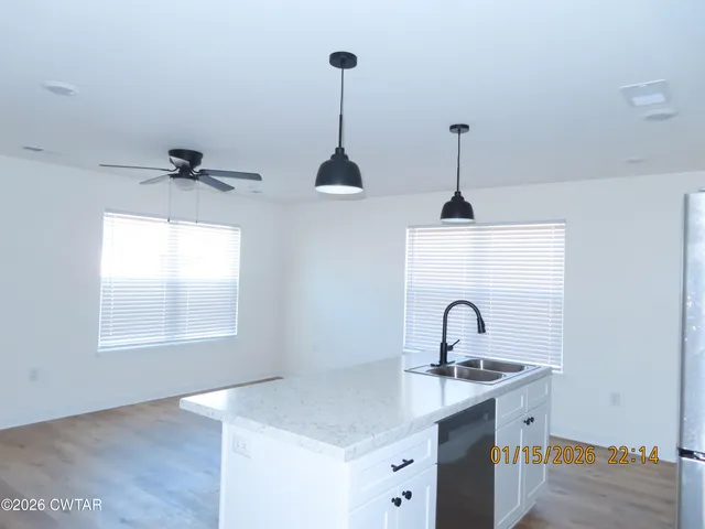 a view of a ceiling fan and a window